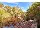 Wooden dock extending over calm, reflecting water at 1237 Schooner Ln, Venice, FL 34285