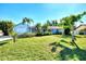 Cute light blue house with palm trees and a spacious lawn at 1237 Schooner Ln, Venice, FL 34285