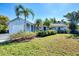 Charming light blue house with a lush green lawn at 1237 Schooner Ln, Venice, FL 34285