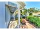 Brick pathway leads to a covered porch with a blue door at 1237 Schooner Ln, Venice, FL 34285