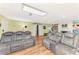 Open living area with hardwood floors and gray sofas at 1237 Schooner Ln, Venice, FL 34285