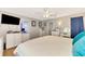 Main bedroom with king bed, built-in shelving, and en-suite bathroom at 1237 Schooner Ln, Venice, FL 34285