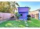 Charming purple playhouse with a small garden at 1237 Schooner Ln, Venice, FL 34285