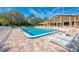 Community pool area with lounge chairs and a covered patio at 1237 Schooner Ln, Venice, FL 34285