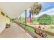 Covered porch with American flag and scenic backyard view at 1237 Schooner Ln, Venice, FL 34285