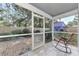 Relaxing screened porch with brick flooring and rocking chair, overlooking backyard at 1237 Schooner Ln, Venice, FL 34285