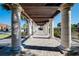 Elegant community walkway with columns and brick pavers at 12385 Amica Loop, Venice, FL 34293