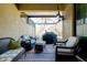 Relaxing screened patio with wicker furniture and grill at 12385 Amica Loop, Venice, FL 34293