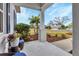 Relaxing front porch with view of neighborhood and lush landscaping at 13589 Old Creek Ct, Parrish, FL 34219