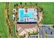 Overhead view of community pool, clubhouse, and parking area at 13756 Vadini St, Venice, FL 34293