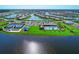 Aerial view showcasing community pool, tennis courts, and lake views at 13756 Vadini St, Venice, FL 34293