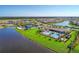 Aerial view of community with lake, pool, and tennis courts at 13756 Vadini St, Venice, FL 34293