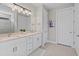 Double vanity bathroom with a large mirror at 13756 Vadini St, Venice, FL 34293