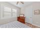 Bright bedroom with a double bed, wooden dresser, and plantation shutters at 13756 Vadini St, Venice, FL 34293