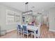 Bright dining area with a white table and blue patterned chairs at 13756 Vadini St, Venice, FL 34293