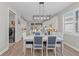 Modern dining area with a white table, blue chairs and kitchen access at 13756 Vadini St, Venice, FL 34293