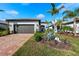 Single-story house with a two-car garage and nicely landscaped yard at 13756 Vadini St, Venice, FL 34293