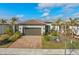 Single-story home with a two-car garage and landscaped front yard at 13756 Vadini St, Venice, FL 34293