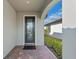Front entry with a covered porch and glass door at 13756 Vadini St, Venice, FL 34293