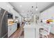 Modern kitchen with white cabinets, island, and stainless steel appliances at 13756 Vadini St, Venice, FL 34293