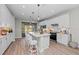Modern kitchen with white cabinets, island, and stainless steel appliances at 13756 Vadini St, Venice, FL 34293