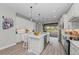 Modern kitchen with white cabinets, island, and stainless steel appliances at 13756 Vadini St, Venice, FL 34293