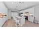 Modern kitchen with white cabinets, island, and stainless steel appliances at 13756 Vadini St, Venice, FL 34293