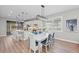 Modern kitchen with white cabinets, island, and stainless steel appliances at 13756 Vadini St, Venice, FL 34293