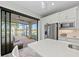 Modern kitchen with island and view of screened patio at 13756 Vadini St, Venice, FL 34293
