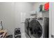Laundry room with washer, dryer, and built-in shelving at 13756 Vadini St, Venice, FL 34293