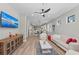 Bright living room with hardwood floors, comfy sofas, and a large TV at 13756 Vadini St, Venice, FL 34293