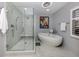 Modern bathroom with a large soaking tub, glass shower, and marble flooring at 1579 Waterford Dr, Venice, FL 34292