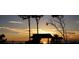 Silhouetted gazebo on the beach at sunset with calm ocean view at 1579 Waterford Dr, Venice, FL 34292
