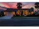 Well-lit home with a two-car garage and landscaped yard at dusk at 1579 Waterford Dr, Venice, FL 34292