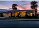 House exterior at dusk showcasing architectural details and landscaping at 1579 Waterford Dr, Venice, FL 34292