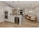 Open kitchen features a large island with wine cooler, stainless steel appliances, and white cabinetry at 1579 Waterford Dr, Venice, FL 34292