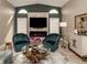 Living room with fireplace, two armchairs and large TV at 1579 Waterford Dr, Venice, FL 34292