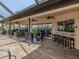 Relaxing pool area with covered patio, seating, and a built-in bar at 1579 Waterford Dr, Venice, FL 34292