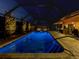 Blue illuminated pool at night at 1579 Waterford Dr, Venice, FL 34292
