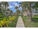 Landscaped walkway with lush tropical foliage and picnic area at 1591 Beach Rd # 204, Englewood, FL 34223