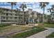 Condo building with patio area and picnic tables at 1591 Beach Rd # 204, Englewood, FL 34223