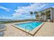 Community pool with waterfront views and lounge chairs at 1591 Beach Rd # 204, Englewood, FL 34223