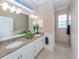Double vanity bathroom with granite countertops and tiled shower at 1634 Monarch Dr # 1634, Venice, FL 34293