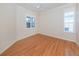 Spacious bedroom with light hardwood floors and two windows at 1634 Monarch Dr # 1634, Venice, FL 34293