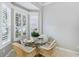 Bright breakfast nook with glass table and wicker chairs at 1634 Monarch Dr # 1634, Venice, FL 34293