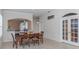 Bright dining room with hardwood table and six chairs at 1634 Monarch Dr # 1634, Venice, FL 34293