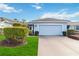 Cute Florida home with light blue exterior, two-car garage, and well-manicured lawn at 1634 Monarch Dr # 1634, Venice, FL 34293
