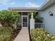 Front entry with screened porch, walkway, and lush landscaping at 1634 Monarch Dr # 1634, Venice, FL 34293