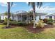 House exterior showcasing backyard landscaping and screened patio at 1634 Monarch Dr # 1634, Venice, FL 34293