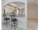 Kitchen features granite countertops, white cabinets, and breakfast bar at 1634 Monarch Dr # 1634, Venice, FL 34293